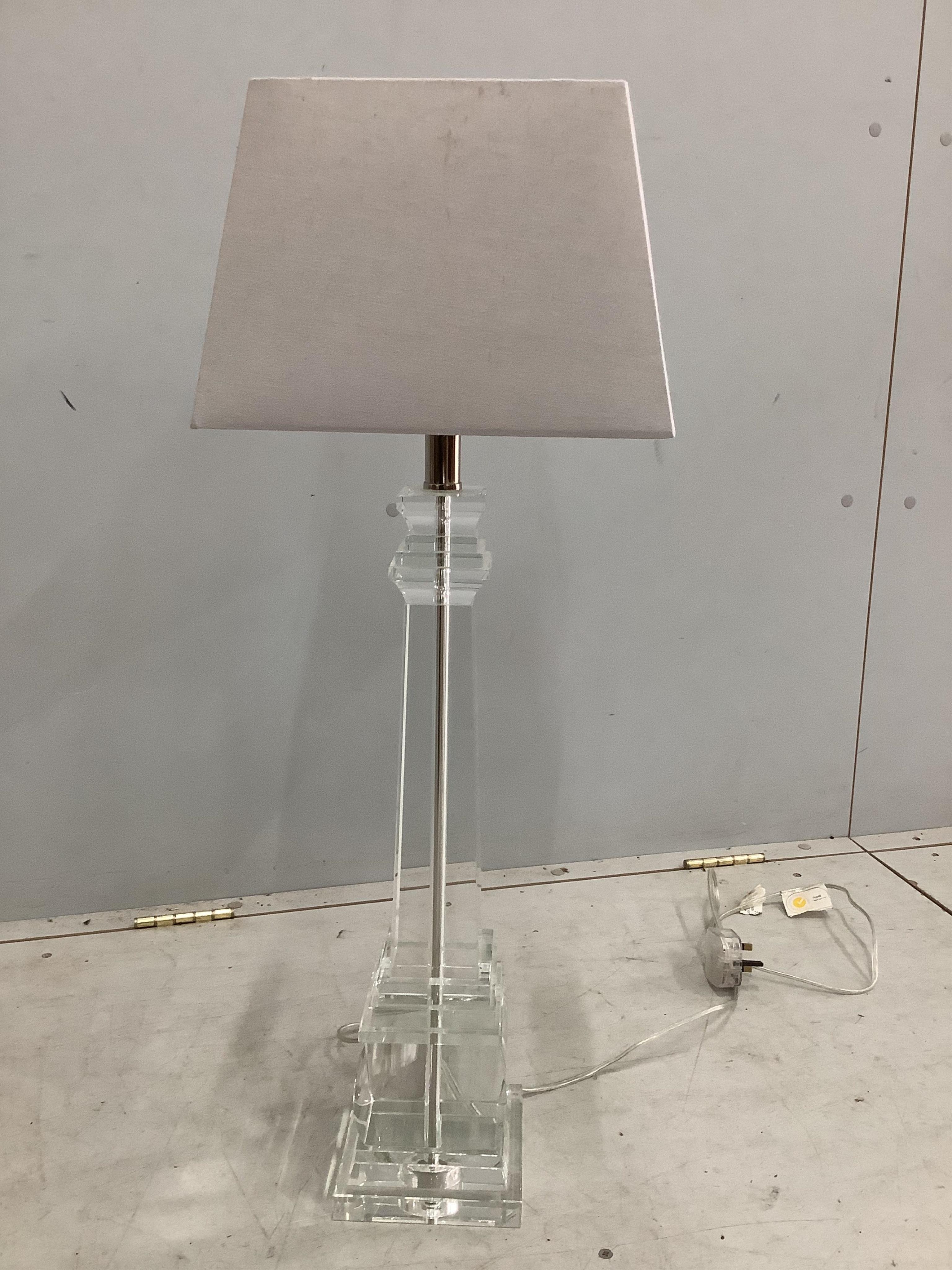 A pair of glass pillar shaped table lamps, 54cm high not including fitment or shade.